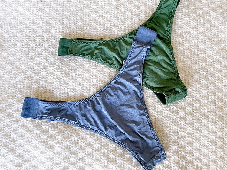 Venta al por mayor Bragas Cintura media Bragas de seda de hielo Una pieza T Back Color sólido Sin costuras Metal V Mujer Ropa interior